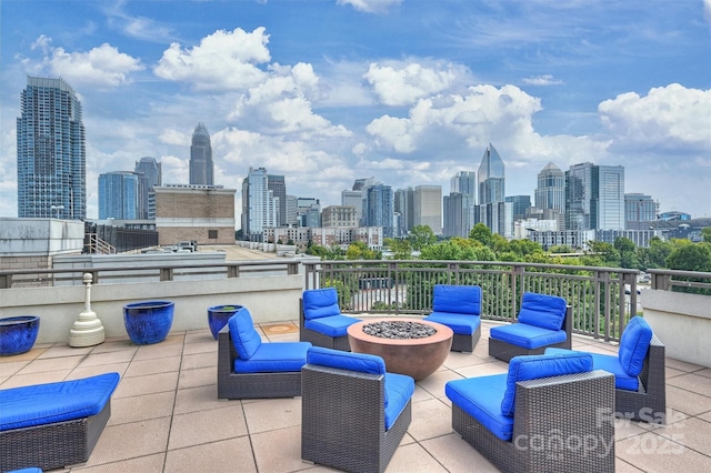 718 W Trade St Unit 105, Charlotte, NC 28202 - view of patio featuring a view of skyline and an outdoor living space with a fire pit