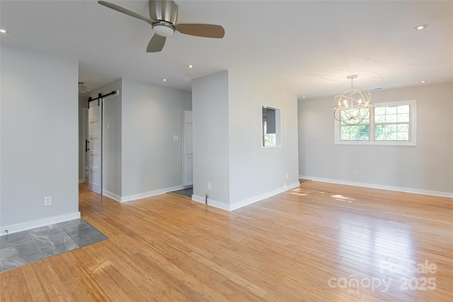 110 Annandale Ave, Asheville, NC 28801 - empty room featuring a barn door, a chandelier, light wood-type flooring, baseboards, and ceiling fan