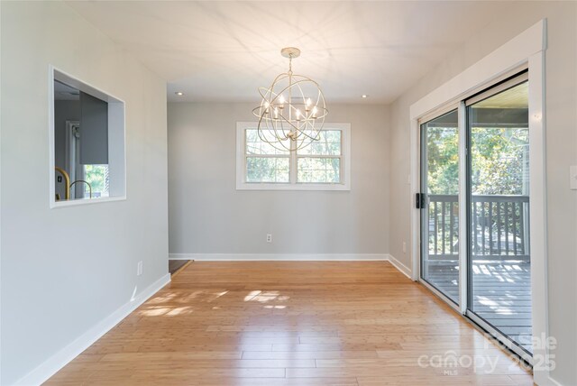 110 Annandale Ave, Asheville, NC 28801 - unfurnished room featuring plenty of natural light, light wood finished floors, a chandelier, baseboards, and recessed lighting