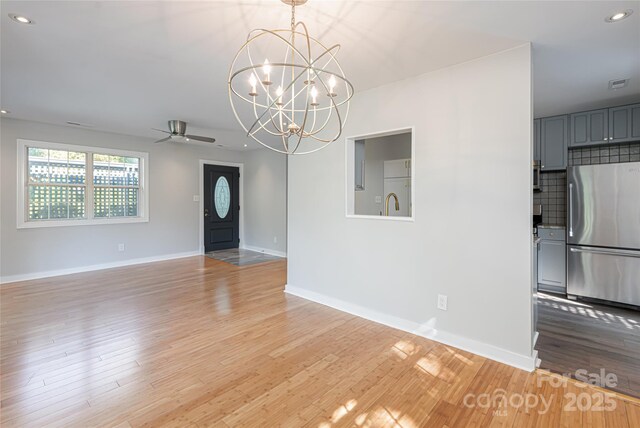 110 Annandale Ave, Asheville, NC 28801 - unfurnished living room with a ceiling fan, a chandelier, recessed lighting, light wood-type flooring, and baseboards