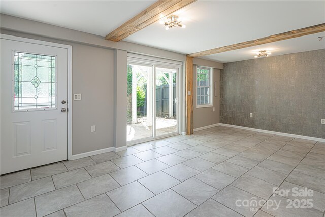 110 Annandale Ave, Asheville, NC 28801 - foyer featuring plenty of natural light, baseboards, beamed ceiling, light tile patterned floors, and an accent wall