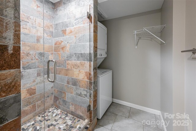 110 Annandale Ave, Asheville, NC 28801 - laundry room featuring estacked washer and dryer, tile patterned floors, and baseboards