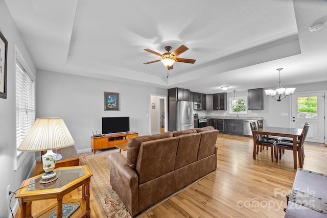17 Laurel Rd, Arden, NC 28704 - living area with a raised ceiling, a chandelier, ceiling fan, light wood finished floors, and baseboards