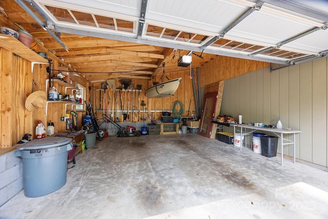 17 Laurel Rd, Arden, NC 28704 - garage featuring a garage door opener, a workshop area, and wooden walls