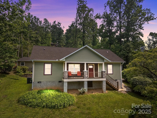 17 Laurel Rd, Arden, NC 28704 - view of front of house with covered porch, a yard, stairway, roof with shingles, and central AC unit