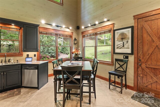 1283 Leafstone Cir, Sylva, NC 28779 - dining area with a towering ceiling, light tile patterned floors, and baseboards
