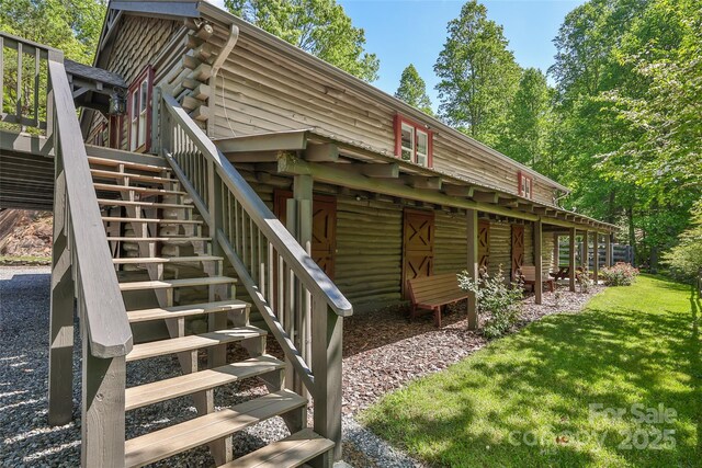 1283 Leafstone Cir, Sylva, NC 28779 - view of side of home with stairway, log siding, a wooden deck, and a yard