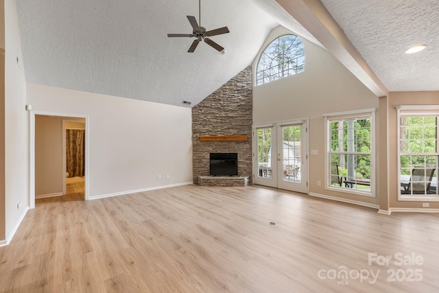 9372 Island Point Rd, Sherrills Ford, NC 28673 - unfurnished living room featuring ceiling fan, a textured ceiling, wood finished floors, a fireplace, and healthy amount of natural light