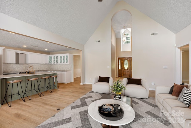 9372 Island Point Rd, Sherrills Ford, NC 28673 - living room with light wood-type flooring, a textured ceiling, high vaulted ceiling, and recessed lighting