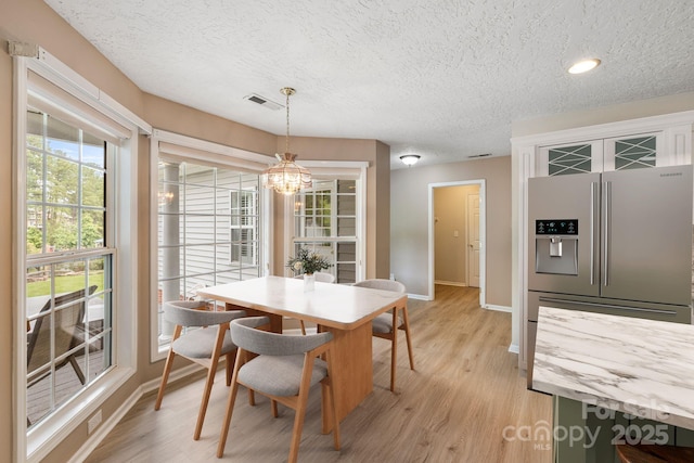 9372 Island Point Rd, Sherrills Ford, NC 28673 - dining area featuring a textured ceiling, light wood-type flooring, a chandelier, and recessed lighting