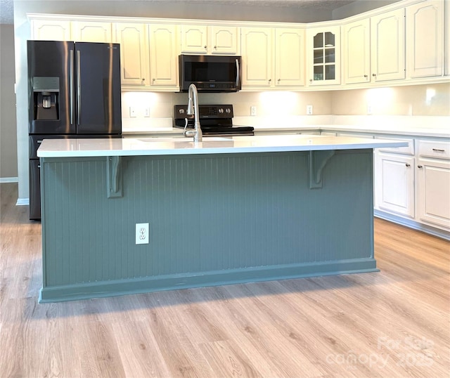 9372 Island Point Rd, Sherrills Ford, NC 28673 - kitchen with stainless steel microwave, light wood-type flooring, refrigerator with ice dispenser, and light countertops