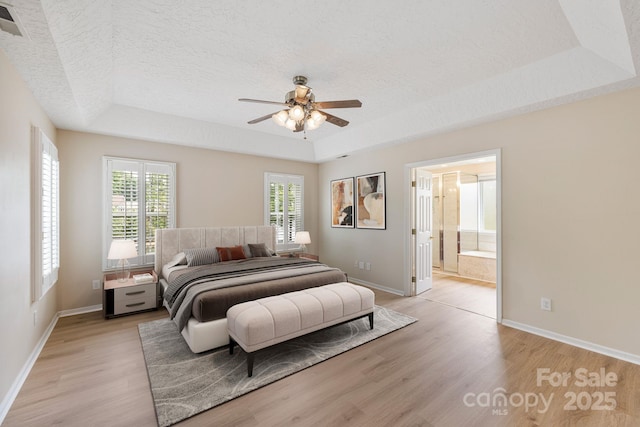 9372 Island Point Rd, Sherrills Ford, NC 28673 - bedroom with a raised ceiling, light wood-style floors, multiple windows, and a textured ceiling