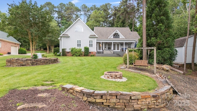 9372 Island Point Rd, Sherrills Ford, NC 28673 - rear view of house featuring an outdoor fire pit, an outbuilding, a yard, and covered porch