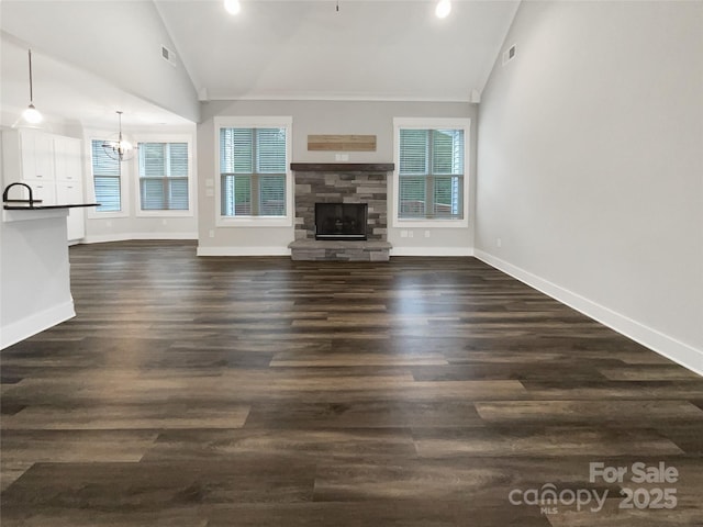 263 Lauren Pines Dr, York, SC 29745 - unfurnished living room with lofted ceiling, a fireplace, a chandelier, baseboards, and dark wood finished floors