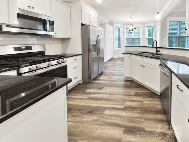 263 Lauren Pines Dr, York, SC 29745 - kitchen with stainless steel appliances, a sink, a chandelier, white cabinets, and healthy amount of natural light