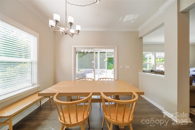 2035 Beacon Ave, Monroe, NC 28110 - dining area featuring a chandelier, crown molding, dark wood finished floors, and baseboards