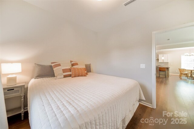 2035 Beacon Ave, Monroe, NC 28110 - bedroom with wood finished floors, baseboards, a chandelier, and ornamental molding