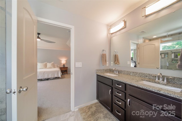 2035 Beacon Ave, Monroe, NC 28110 - ensuite bathroom featuring double vanity, a shower with shower door, ceiling fan, and baseboards