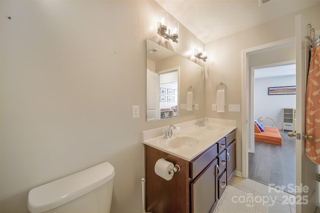 2035 Beacon Ave, Monroe, NC 28110 - bathroom featuring toilet, double vanity, and tile patterned flooring