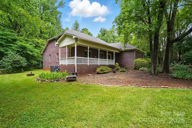 7725 Whitmire Ln, Mint Hill, NC 28227 - view of side of property with a yard, brick siding, and covered porch