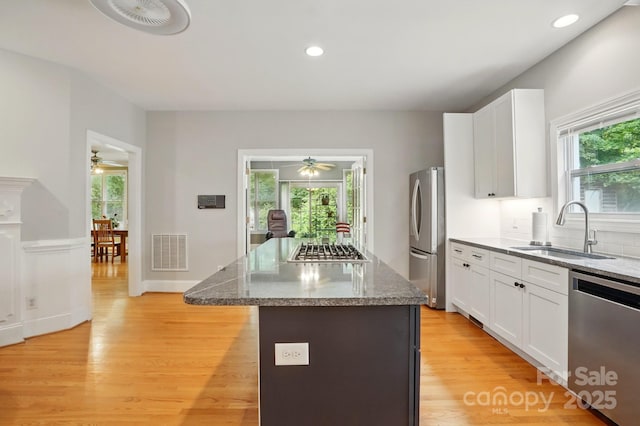 7725 Whitmire Ln, Mint Hill, NC 28227 - kitchen with appliances with stainless steel finishes, a sink, ceiling fan, light wood-type flooring, and recessed lighting