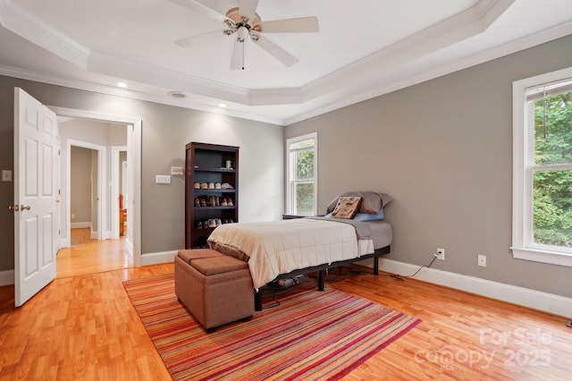 7725 Whitmire Ln, Mint Hill, NC 28227 - bedroom with a tray ceiling, crown molding, light wood-type flooring, baseboards, and a ceiling fan