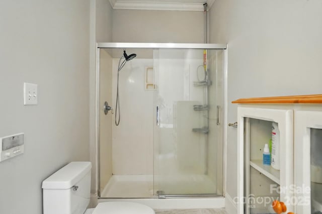 7725 Whitmire Ln, Mint Hill, NC 28227 - bathroom with toilet, a shower stall, and ornamental molding