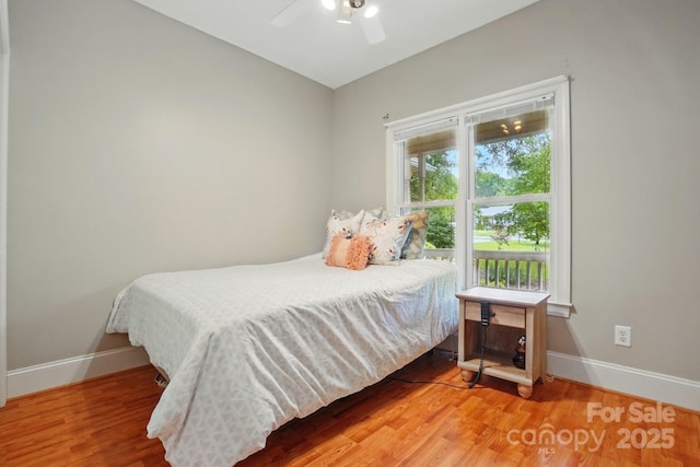 7725 Whitmire Ln, Mint Hill, NC 28227 - bedroom with baseboards, wood finished floors, and a ceiling fan