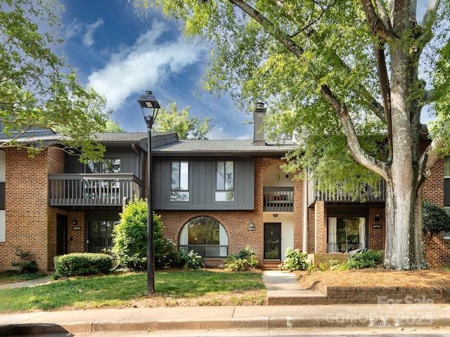 5809 Sharon Rd Unit G, Charlotte, NC 28210 - view of property featuring a balcony, board and batten siding, and brick siding