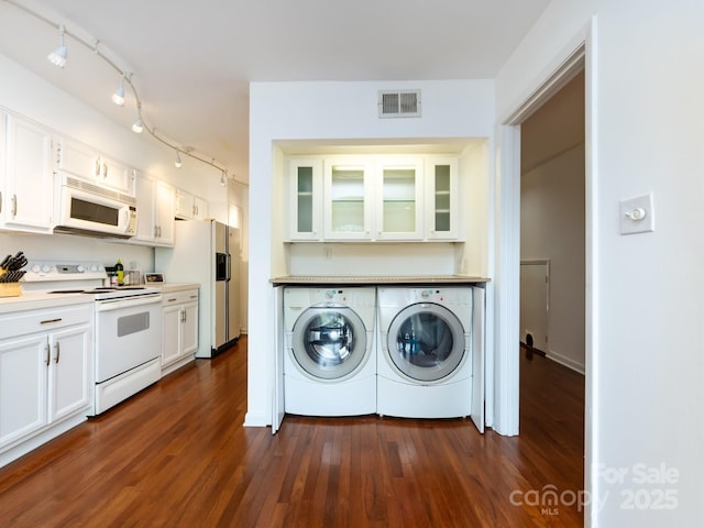 5809 Sharon Rd Unit G, Charlotte, NC 28210 - washroom featuring washing machine and clothes dryer, rail lighting, and dark wood-type flooring