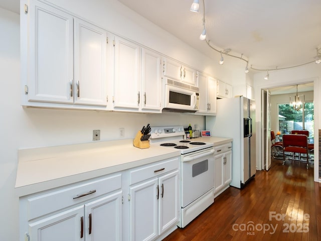 5809 Sharon Rd Unit G, Charlotte, NC 28210 - kitchen with white appliances, white cabinetry, a chandelier, and light countertops