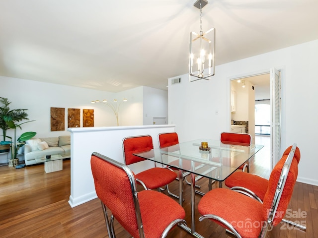 5809 Sharon Rd Unit G, Charlotte, NC 28210 - dining area featuring a chandelier and wood finished floors