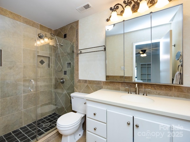 5809 Sharon Rd Unit G, Charlotte, NC 28210 - full bath featuring vanity, toilet, a stall shower, a ceiling fan, and tile walls