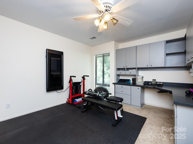 5809 Sharon Rd Unit G, Charlotte, NC 28210 - workout area featuring built in desk, a ceiling fan, baseboards, and light carpet