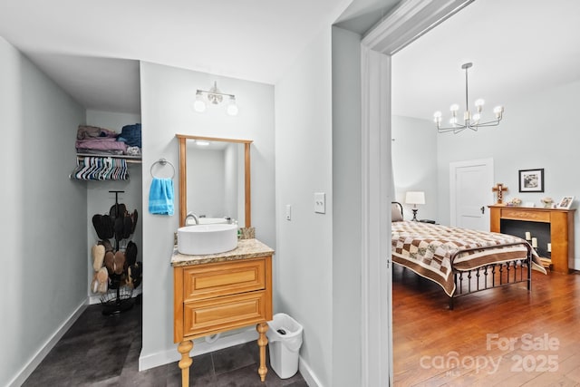 606 1st St W, Conover, NC 28613 - bathroom with vanity, a chandelier, and baseboards