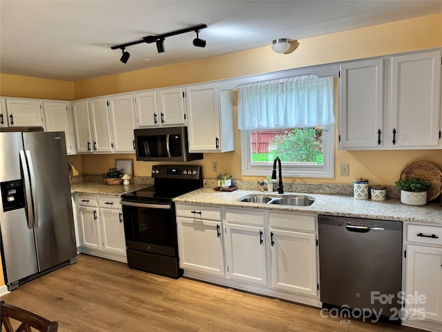 1228 Hidden Creek Cir, Hickory, NC 28602 - kitchen featuring stainless steel appliances, a sink, white cabinetry, and light stone countertops