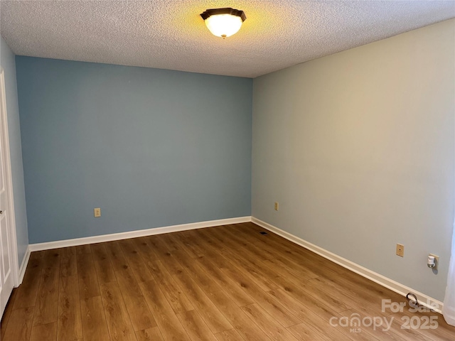 1228 Hidden Creek Cir, Hickory, NC 28602 - spare room with wood finished floors, a textured ceiling, and baseboards