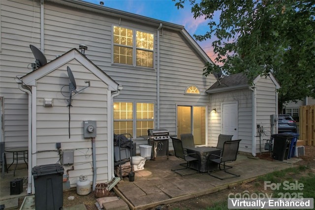 945 Heritage Pkwy, Fort Mill, SC 29715 - back of house at dusk featuring a patio area
