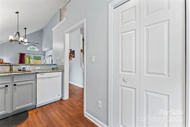 945 Heritage Pkwy, Fort Mill, SC 29715 - kitchen with white dishwasher, a sink, light wood finished floors, a chandelier, and baseboards