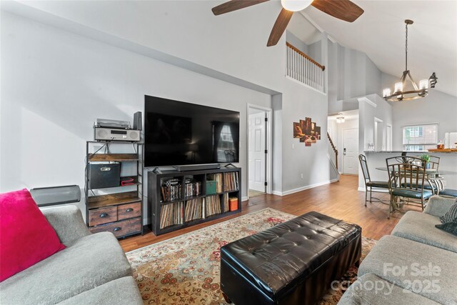 945 Heritage Pkwy, Fort Mill, SC 29715 - living area featuring high vaulted ceiling, a chandelier, stairway, wood finished floors, and a ceiling fan