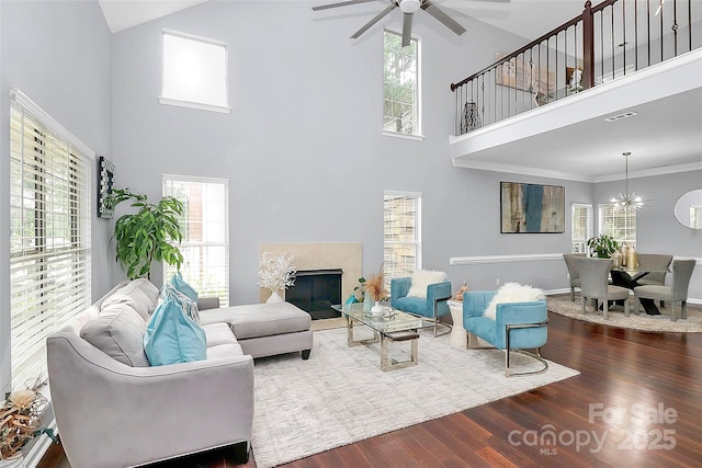 10449 Quiet Bay Ct, Charlotte, NC 28278 - living room featuring high vaulted ceiling, ceiling fan, dark wood-type flooring, a fireplace, and a chandelier