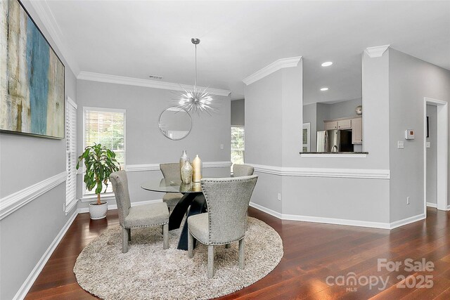 10449 Quiet Bay Ct, Charlotte, NC 28278 - dining space with plenty of natural light, wood finished floors, baseboards, crown molding, and recessed lighting