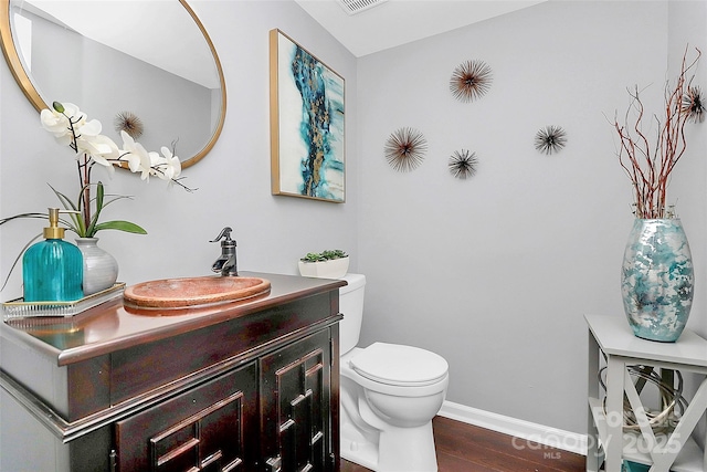 10449 Quiet Bay Ct, Charlotte, NC 28278 - bathroom featuring toilet, vanity, wood finished floors, and baseboards