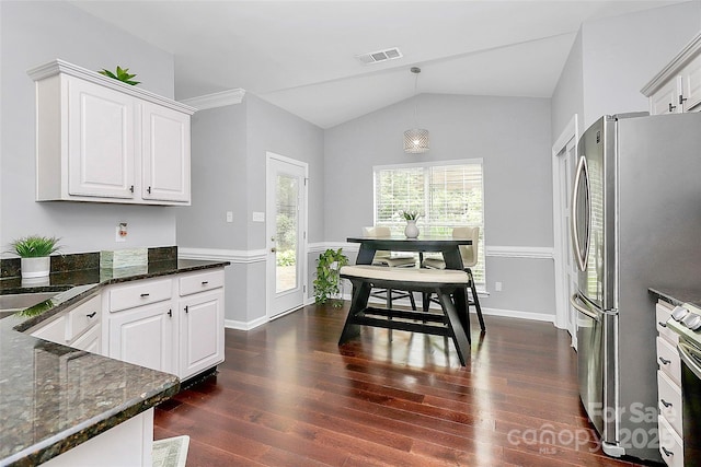 10449 Quiet Bay Ct, Charlotte, NC 28278 - kitchen featuring dark wood-type flooring, vaulted ceiling, white cabinetry, freestanding refrigerator, and dark stone countertops