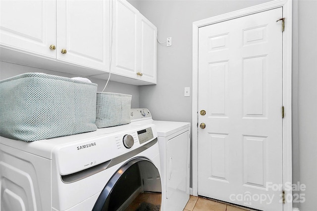 10449 Quiet Bay Ct, Charlotte, NC 28278 - laundry room with cabinet space, washing machine and dryer, and light tile patterned flooring