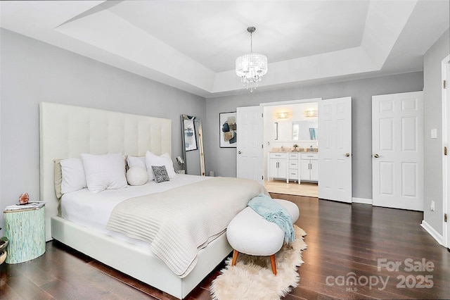 10449 Quiet Bay Ct, Charlotte, NC 28278 - bedroom with a tray ceiling, a chandelier, wood finished floors, connected bathroom, and baseboards