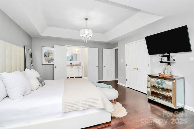 10449 Quiet Bay Ct, Charlotte, NC 28278 - bedroom with a tray ceiling, dark wood-style flooring, a chandelier, and baseboards