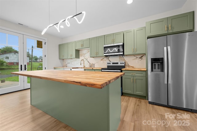1076 W Henderson St, Marion, NC 28752 - kitchen featuring appliances with stainless steel finishes, green cabinets, butcher block counters, a sink, and recessed lighting