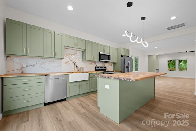 1076 W Henderson St, Marion, NC 28752 - kitchen featuring green cabinets, stainless steel appliances, wooden counters, a sink, and recessed lighting