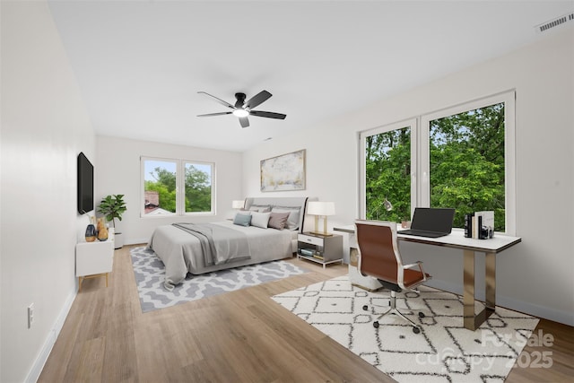 1076 W Henderson St, Marion, NC 28752 - bedroom featuring light wood finished floors, a desk, baseboards, and ceiling fan